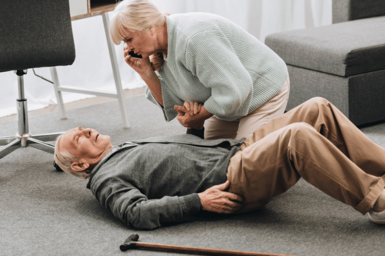 A wife caring for her husband who has fallen while calling for help.