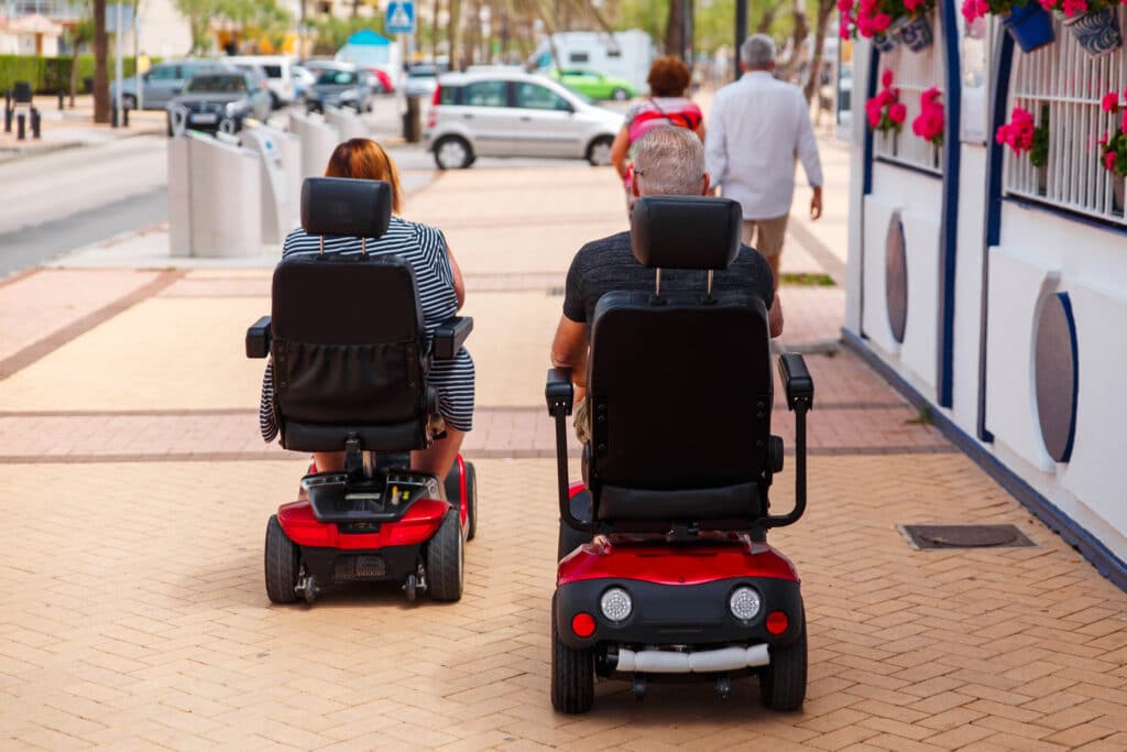 Two people use rental mobility scooters in Arizona from Copper Star