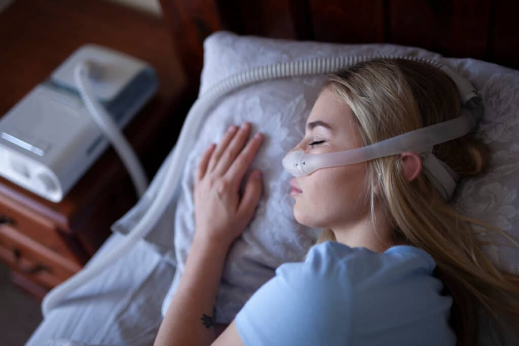 woman uses cpap machine from copper star home medical supplies to sleep