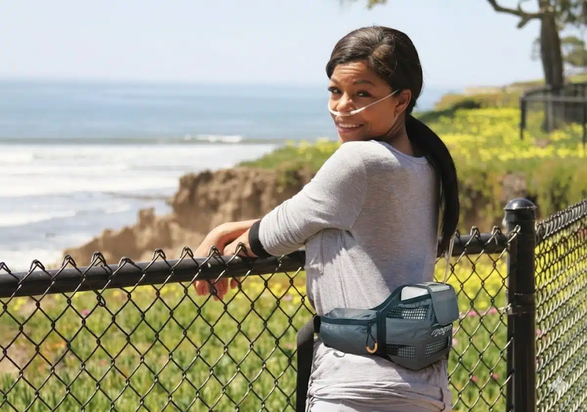 A woman enjoying an outing to a beach with a portable oxygen concentrator from Alpine Home Medical